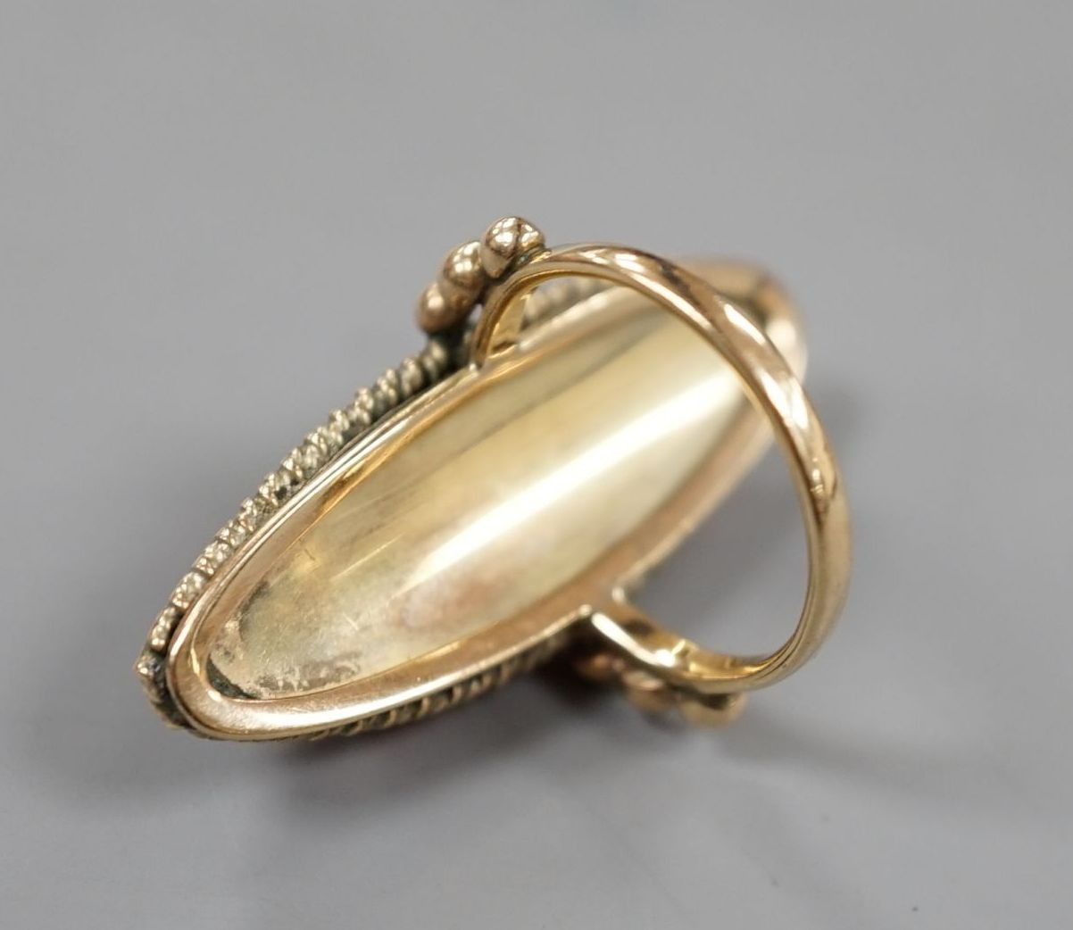 A large yellow metal and amber set marquise shaped dress ring, size N, gross weight 7.6 grams.